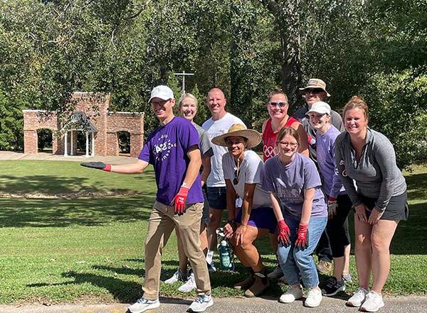 Converse faculty and staff stand in front of Rainey Ampitheater after assisting with cleanup.